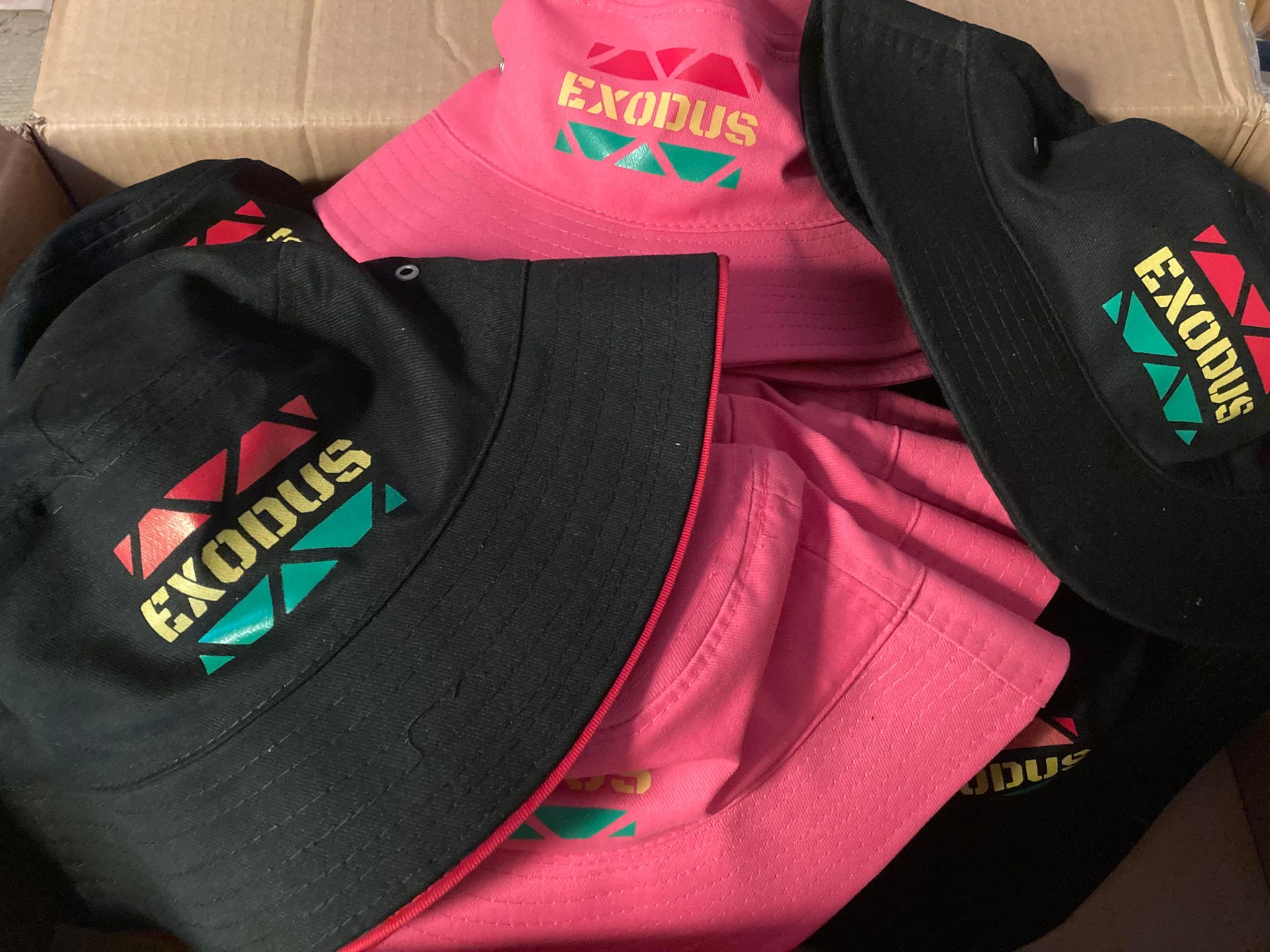 Exodus Merch Display — Hats & Tees